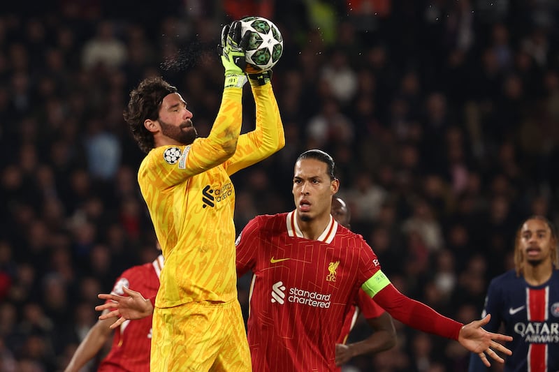 Liverpool's Brazilian goalkeeper Alisson catches the ball in front of Virgil van Dijk during the Champions League game in Paris. Photograph: Franck Fife/AFP via Getty