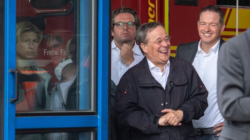 North Rhine-Westphalia’s state premier, Christian Democratic Union (CDU) leader and CDU’s candidate for chancellery Armin Laschet (centre) laughs  during a  visit to the Rhein-Erft fire and rescue control centre and in Erftstadt, western Germany on Saturday. Photograph: Getty