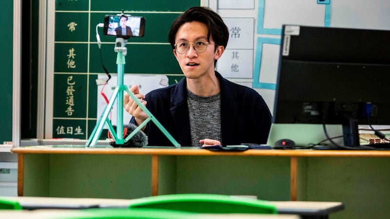 Primary school teacher Billy Yeung is recording video lessons for his students who have had their classes suspended due to the coronavirus in Hong Kong Photograph: Isaac Lawrence/AFP via Getty Images