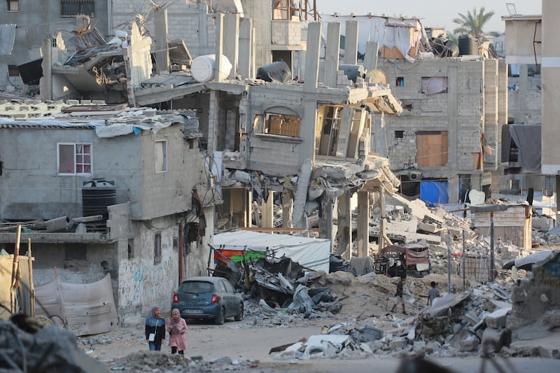 People walk past destroyed buildings in Khan Yunis in the southern Gaza Strip on October 17th. Photograph: Bashar Taleb/AFP via Getty