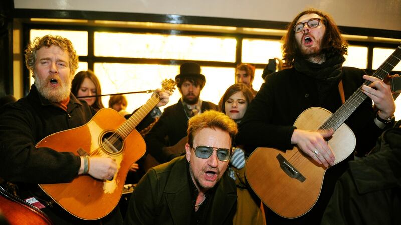 Glen Hansard, Bono and Hozier singing on Grafton Street on Christmas Eve. Photograph: Aidan Crawley/ The Irish Times