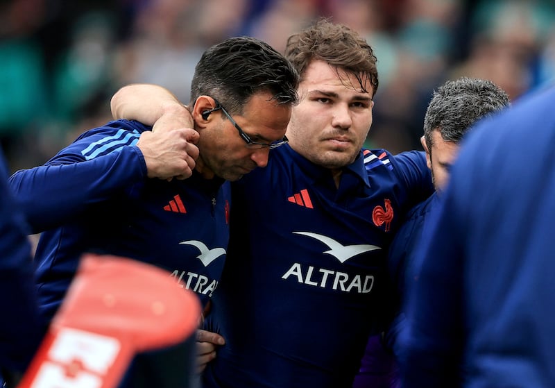 France's Antoine Dupont leaves the pitch after an injury. Photograph: Dan Sheridan/Inpho