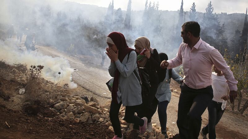 Palestinians run away from tear gas fired by Israeli forces during clashes over an Israeli order to shut down a Palestinian school in the town of as-Sawiyah, south of Nablus, in the occupied West Bank on October 15th. Photograph: Jaafar Ashtiyeh /AFP/Getty Images