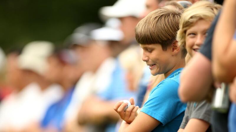 Jackson Ward (9) of West Orange, New Jersey, holds a ball rolled to him by Rory McIlroy on the fifth tee during the third round of The Barclays at The Ridgewood Country Club   in Paramus, New Jersey. Photograph:  Darren Carroll/Getty Images