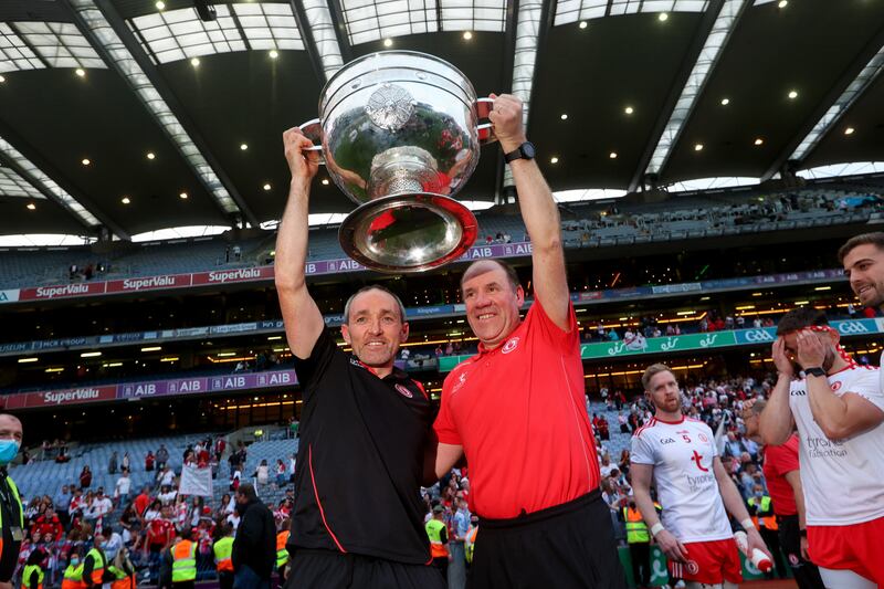 Brian Dooher and Feargal Logan lift the Sam Maguire in Croke Park in September 2021 after Tyrone defeated Mayo. Photograph: Ryan Byrne/Inpho