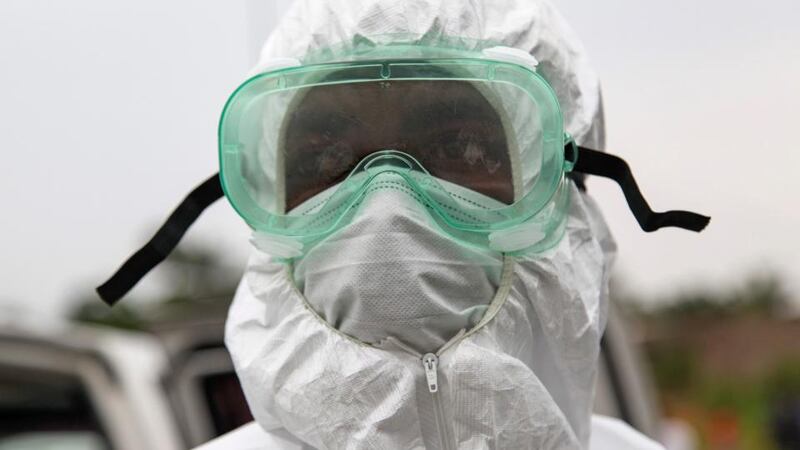 A Liberian nurse wearing protective clothing during the removal and burial of an Ebola victim in the Virginia community on the outskirts of Monrovia, Liberia. Photograph: Ahmed Jallanzo/EPA