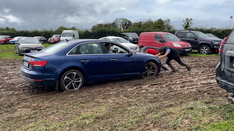 A stuck car is pushed out of the mud on Tuesday. Photograph: Niall Carson/PA Wire 