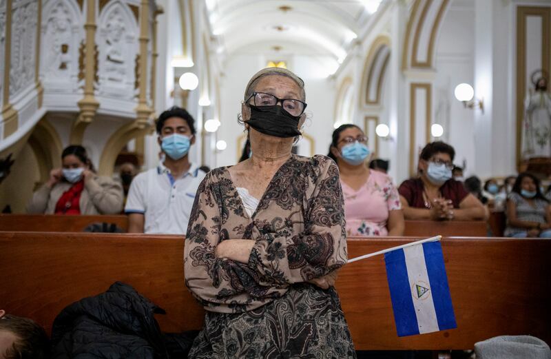 Xiomara Tinoco, 59, holds a Nicaraguan flag as she prays at the cathedral in Matagalpa, 60 miles north of Managua, Nicaragua, in August. Photograph: Inti Ocón/New York Times