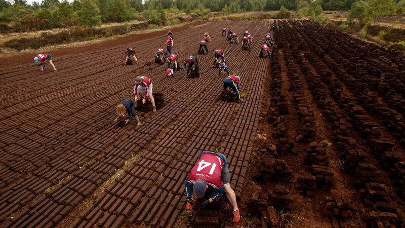 Members Of Daingean GAA Club help foot turf for vulnerable members of the community. Photo: James Crombie/Inpho