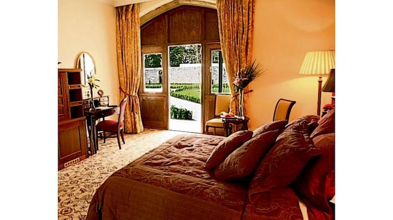 Refuge: the Baronial Hall at Lough Rynn Castle Hotel, and one of its French Stables bedrooms (below)