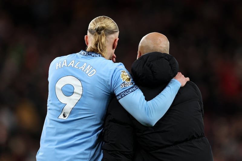 Manchester City's Norwegian striker Erling Haaland hugs manager Pep Guardiola following the English Premier League football match against Liverpool. Photograph: Adrian Dennis/AFP