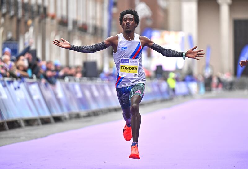 Hiko Tonosa celebrates on his way to winning the Irish National Championships and finishing third overall during the 2024 Irish Life Dublin Marathon. Photograph: Sam Barnes/Sportsfile