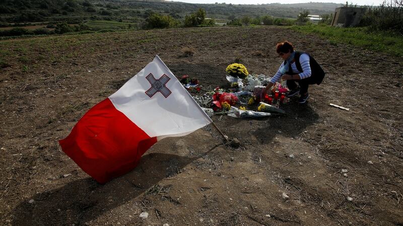 A woman places flowers at the scene of the assassination of Daphne Caruana Galizia, killed in a car bomb attack in Bidnija, Malta on October 26th, 2017. Photograph: Darrin Zammit Lupi/Reuters