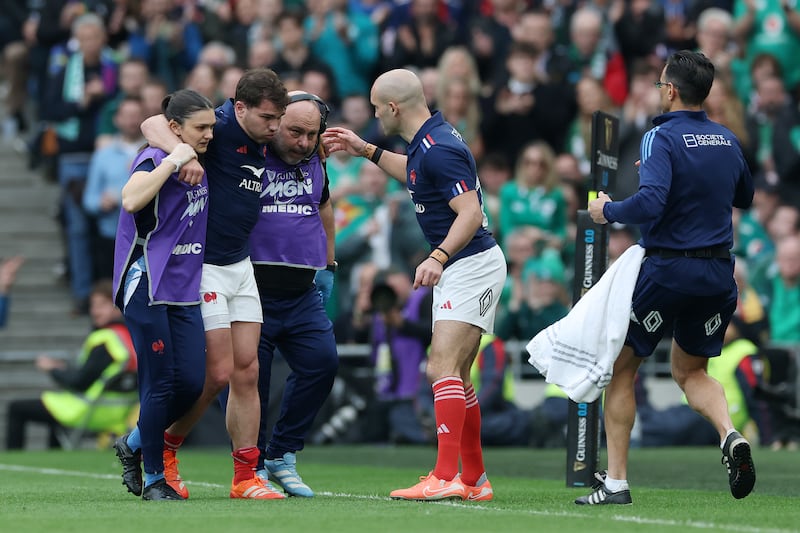 Antoine Dupont is helped off the pitch after sustaining a knee injury. Photograph: David Rogers/Getty Images