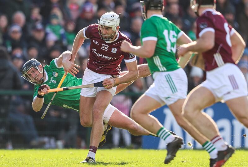 Galway's Jason Flynn runs past the challenge of Darragh O'Donovan of Limerick. Photograph: Tom Maher/Inpho