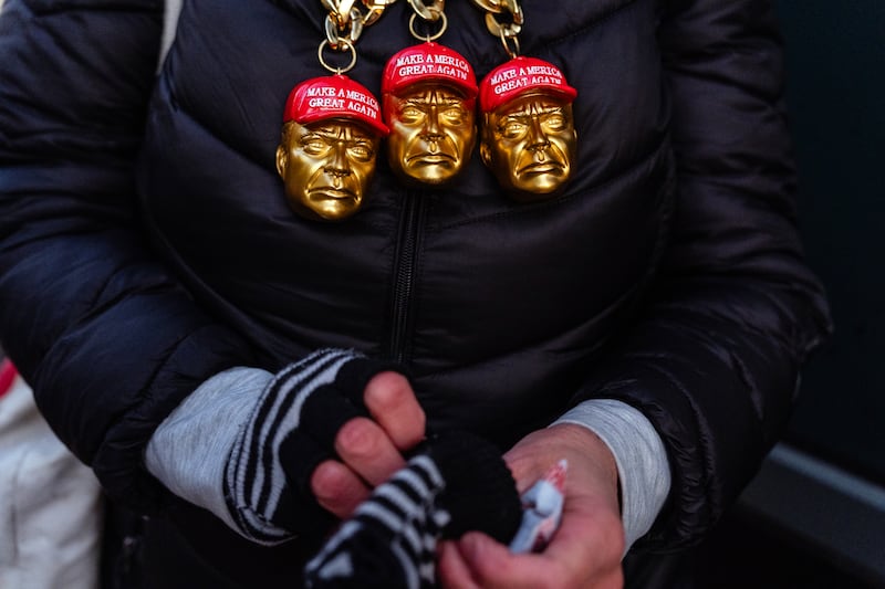 A woman wearing necklaces in support of Donald Trump waits in line to enter the Capitol One Arena in Washington DC on Monday before the US presidential inauguration ceremony. Photograph: Eric Lee/The New York Times
                      