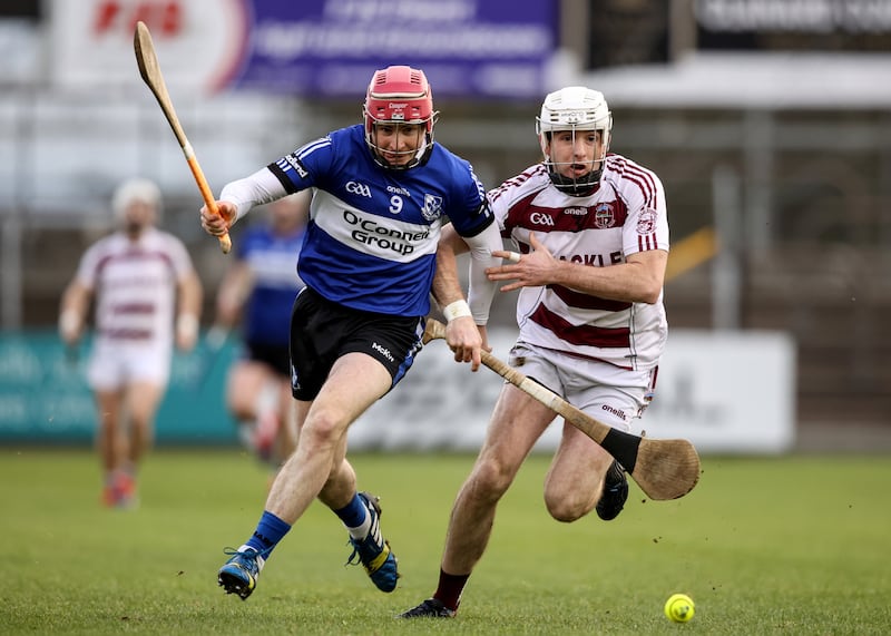 Sarsfields' Daniel Kearney and Paul McNeill of Slaughtneil compete for possession. Photograph: Ben Brady/Inpho