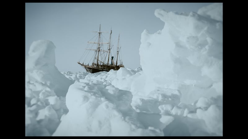 The Endurance stuck in ice, as seen from behind a collection of crunched up ice floes.  (credit: RGS/Frank Hurley)