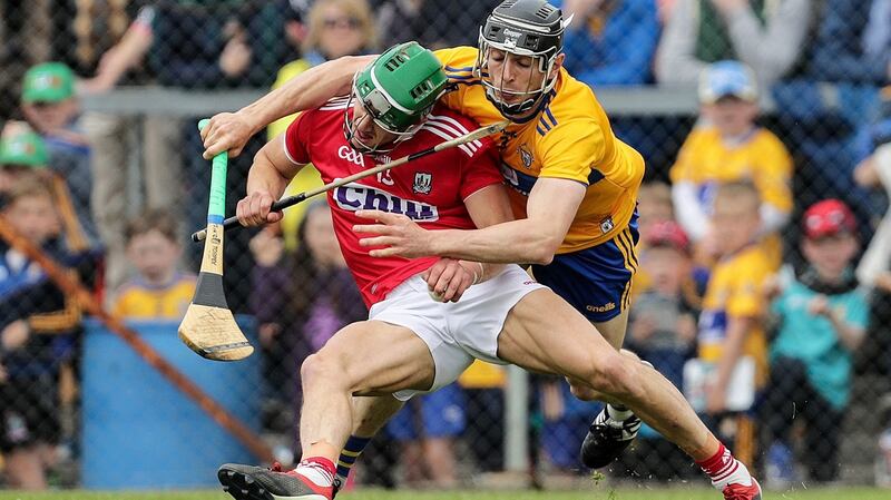 Clare’s David McInerney challenges   Cork’s Alan Cadogan during the during the Munster SHC round-robin match at Cusack Park in Ennis. Photograph: Laszlo Geczo/Inpho