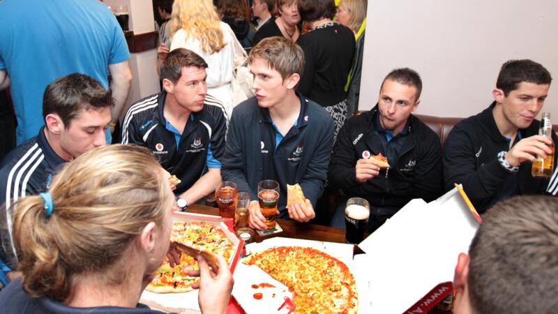 Taking a break: All-Ireland football champions Dublin enjoy some homecoming pizza in 2011. Photograph: Morgan Treacy/Inpho