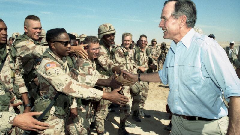 The then US president George HW Bush greets American troops in Saudi Arabia weeks before the start of the Gulf war in 1991. Photograph: The New York Times