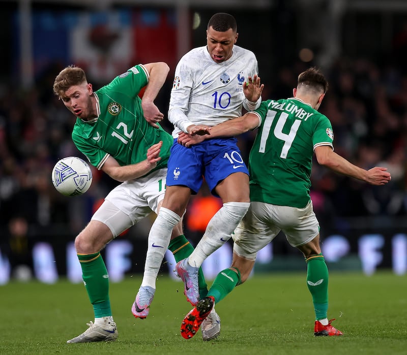 Ireland’s Nathan Collins and Jayson Molumby with Kylian Mbappé of France. Photograph: Ryan Byrne/Inpho