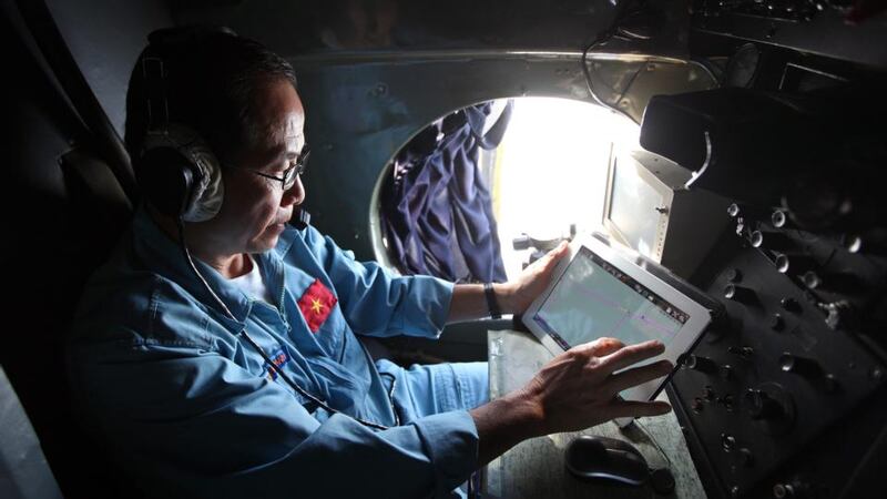 A military official works inside a flying Soviet-made AN-26 of the Vietnam Air Force during search and rescue (SAR) operations for a missing Malaysian Airlines flight, off Vietnam’s sea today. Photograph: EPA