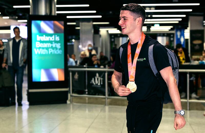 Rhys McClenaghan arrives in Dublin airport with his gold medal. Photograph: Ben Brady/Inpho