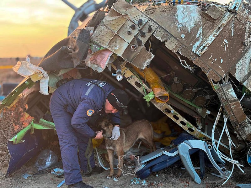 A rescuer searches the wreckage of the aircraft. Photograph: Kazakhstan’s Emergency Ministry Press Service/AP