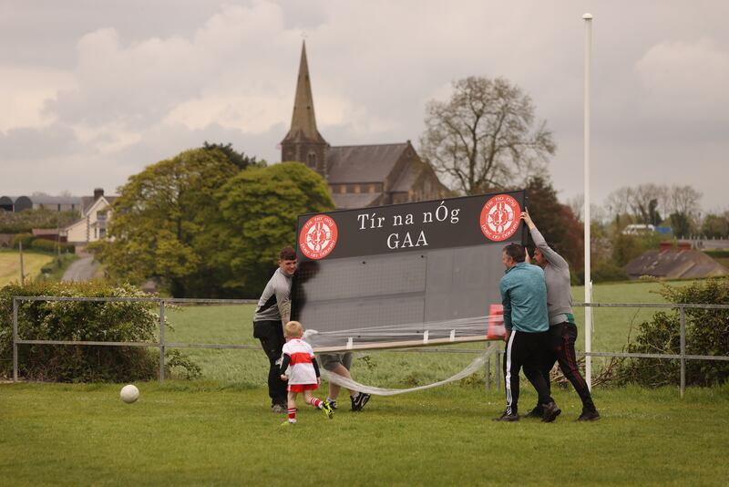 A new scoreboard is erected  at Tir na nÓg GAA club in Fr O'Rafferty Park in Portadown Co. Armagh on Saturday as the coronation of King Charles III took place. In the background is Drumcree Church.  Photo: Bryan O Brien / The Irish Times 
