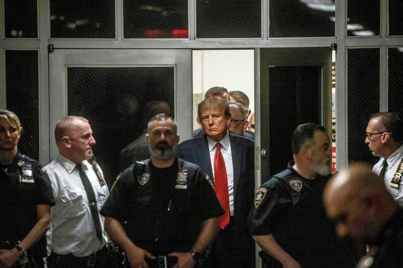 Former US president Donald Trump leaves the district attorney’s office on his way to the courtroom at Manhattan criminal court. In court, assistant district attorney Christopher Conroy said Trump’s payments had been made to “conceal an illegal conspiracy to undermine the integrity of the 2016 presidential election”. Photograph: Dave Sanders/New York Times
                      