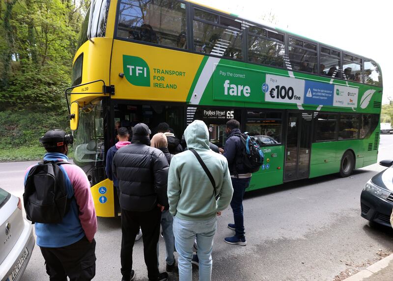 A group of people who claimed to have arrived at the Crooksling accommodation on Wednesday morning board a bus into the city centre the same afternoon. Photograph: Colin Keegan/Collins Dublin