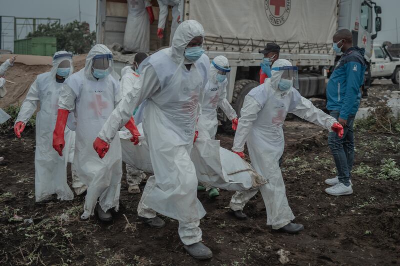 Volunteers bury those who died during a week of clashes, in Goma this week. Photograph: Guerchom Ndebo/New York Times
                      