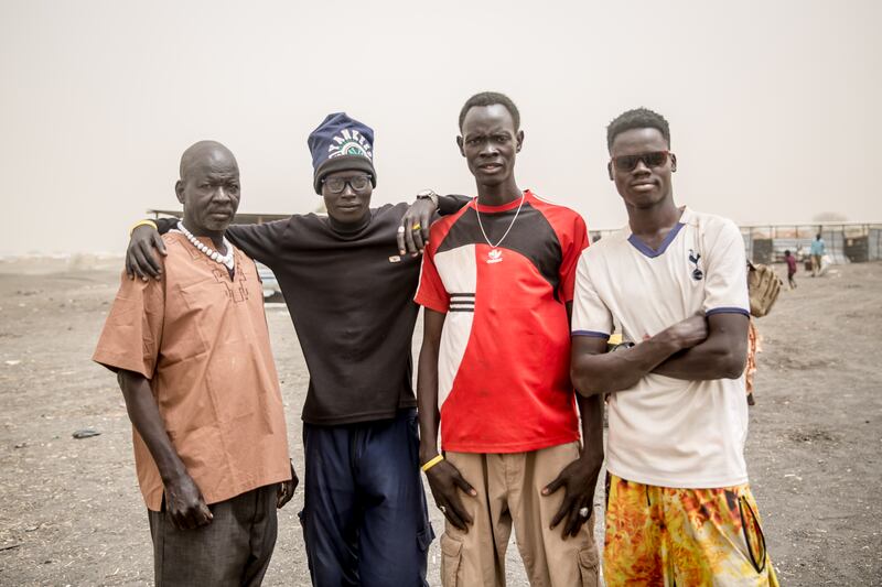 James Ngor (second from left), a 21-year-old travelling with nine family members, says they have one phone between them, but it won't connect to any network. Photograph: Sally Hayden