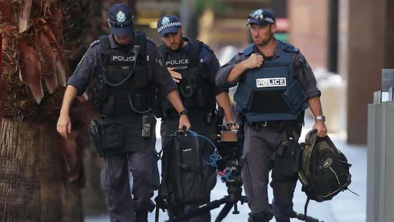 Police move items on Philip St near the Lindt cafe on Martin Place in Sydney. Photograph: Getty