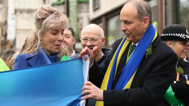 Taoiseach Micheál Martin  with London-based Ukrainian Natalia Lesyuk (left) during the St Patrick’s Day parade in London. Photograph: James Manning/PA Wire