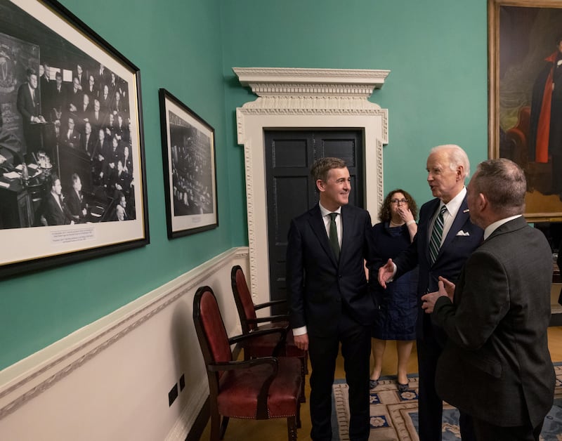 US President Joe Biden looking at a photograph of President John F Kennedy making his address in Leinster House in 1963 at Leinster House before his own joint address to the Houses of the Oireachtas with Mark Daly, Leas-Chathaoirleach of Seanad Éireann and Senator Jerry Buttimer, Cathaoirleach of Seanad Éireann. Photograph: Maxwells