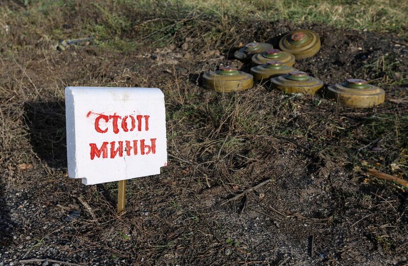 A sign reads 'Stop mines' set up next to during a demining operation not far from Bakhmut, Donetsk region, Ukraine. Photograph: Alessandro Guerra/EPA-EFE