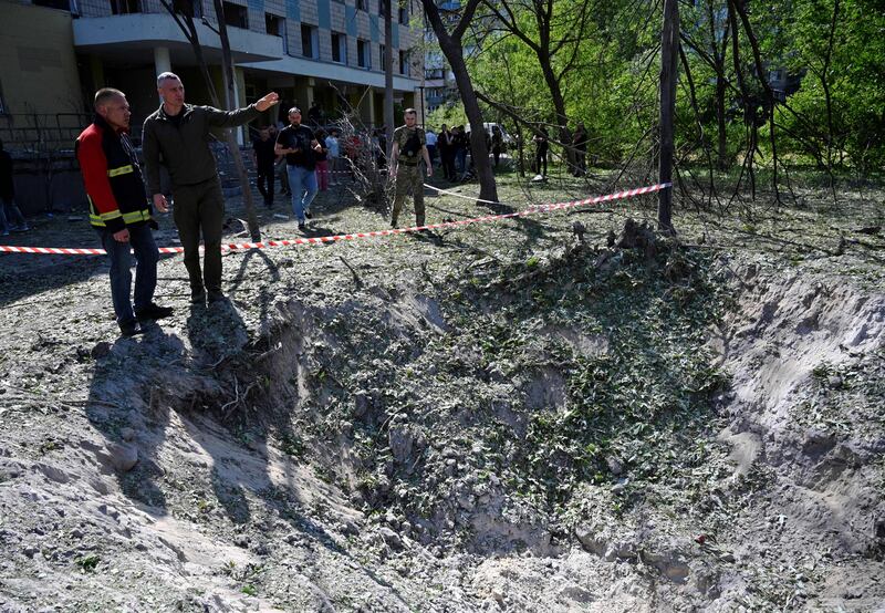 Mayor of the Ukrainian capital Kyiv, Vitali Klitschko (second from right) speaks with a rescue worker as he examines a crater near a polyclinic damaged as a result of a downed missile explosion during the Russian attack. Photograph: Sergei Chuzavkov/AFP via Getty