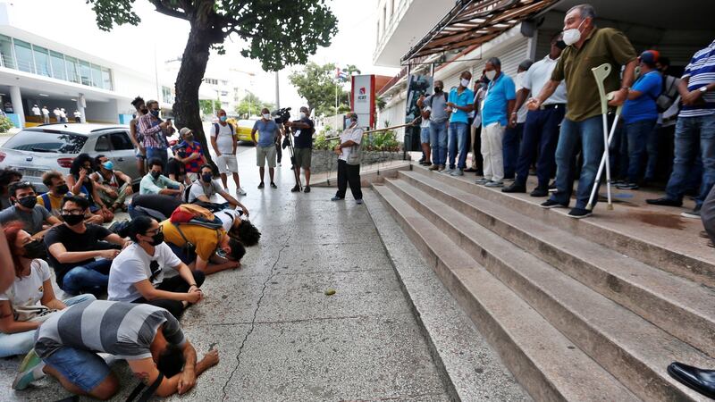 Demonstrators (L) protest in front of workers of the Institute of Radio and Television  in Havana, Cuba.  Photograph: Ernesto Mastrascusa/EPA