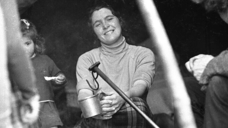 Archive photograph of  Travellers around a camp fire. Photograph: National Folklore Collection, UCD