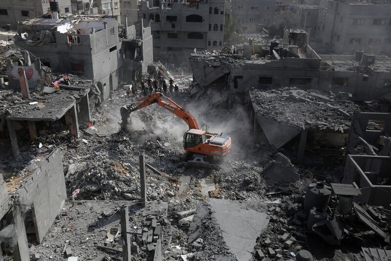 People look on as rubble left by Israel airstrikes is cleared in Khan Younis, in southern Gaza. Photograph: Yousef Masoud/The New York Times
                      