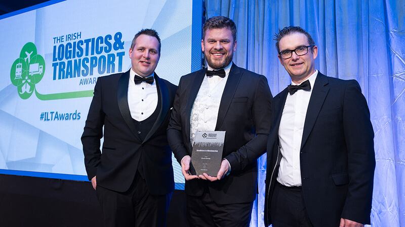 Conor Mannion, Business Development Manager Ireland, AutoStore, presents the Excellence in Warehousing award to Martin Fitzgerald & David Smyth, Classic Drinks.