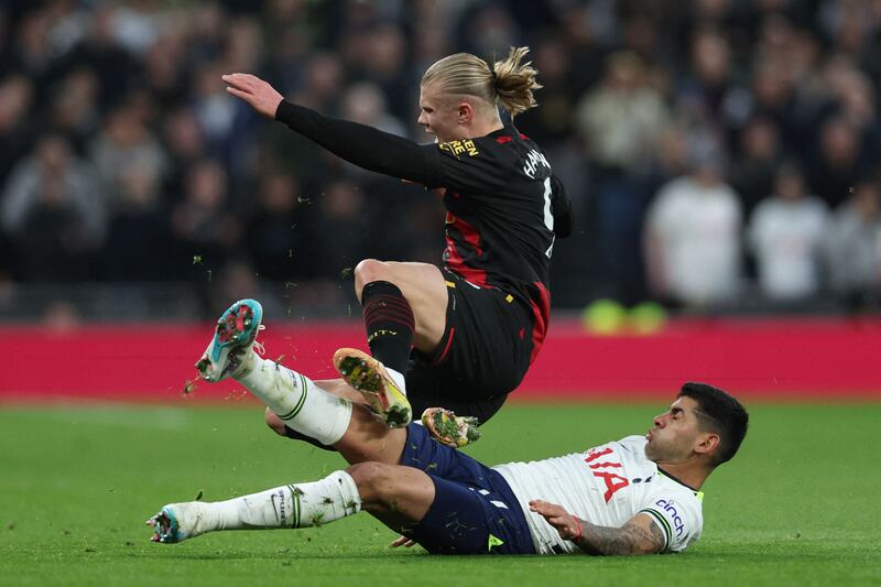 Striking contrast: Cristian Romero takes down Erling Haaland, who had little joy on a day that belonged to Harry Kane and Spurs. Photograph: Photograph: Adrian Dennis/AFP via Getty Images