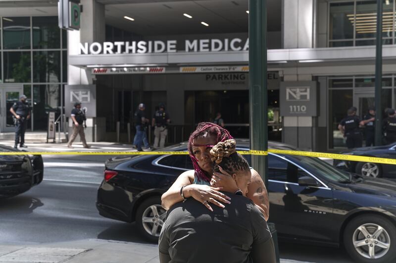 Angela Cooper and Jamese Nathan embrace outside Northside Hospital medical facility as police officers work the scene of a shooting  in Atlanta, Georgia, on May 3rd. Photograph:  Megan Varner/Getty Images