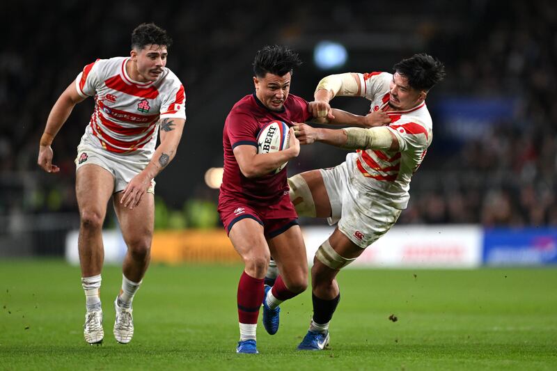 LONDON, ENGLAND - NOVEMBER 24: Marcus Smith of England fends off Takato Okabe of Japan during the Autumn Nations Series 2024 match between England and Japan at Allianz Stadium on November 24, 2024 in London, England. (Photo by Shaun Botterill/Getty Images)