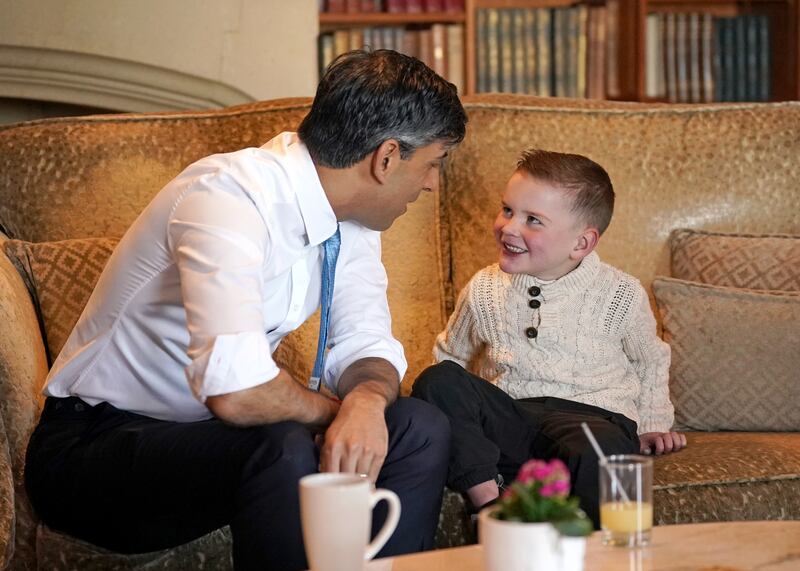 Rishi Sunak presents six-year-old Dáithí Mac Gabhann with an award recognising "outstanding volunteers" for his contribution to his community at the Culloden Hotel in Belfast. Photograph: Niall Carson/PA