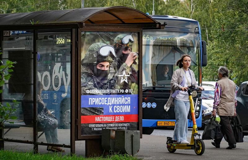 A poster in Moscow advertising military conscription. Statements by Russian officials have gradually signalled that mobilised men are expected to keep fighting until the war ends. Photograph: Yuri Kochetkov/EPA