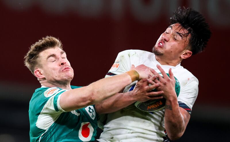 Ireland’s Garry Ringrose challenges Marcus Smith of England in the air. Photograph: Billy Stickland/Inpho