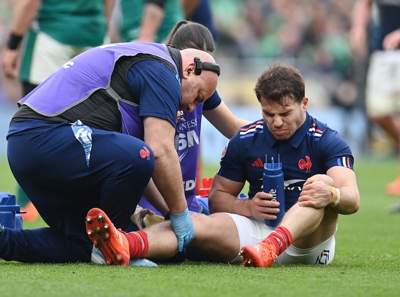 France's Antoine Dupont receiving medical treatment before leaving the field in the game against Ireland. Photograph: Charles McQuillan/Getty Images